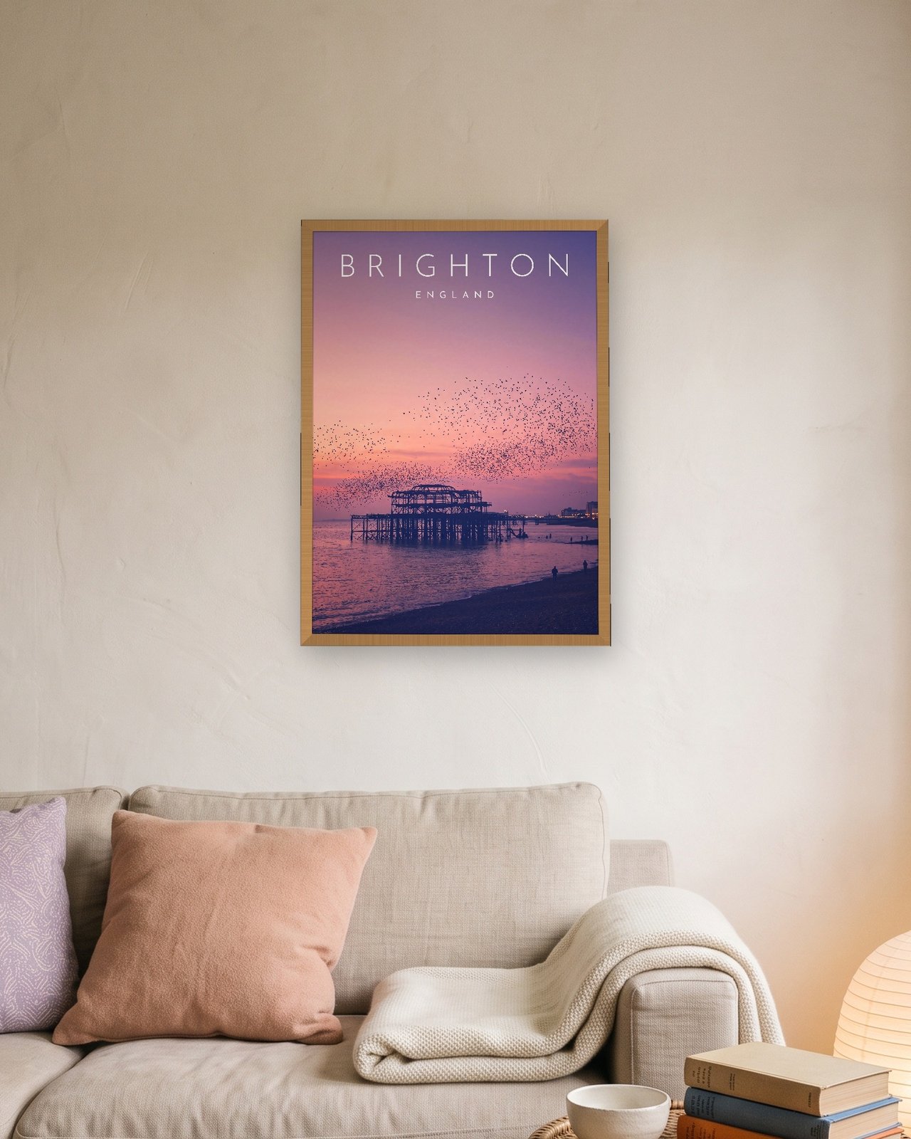 Brighton West Pier at Sunset print, natural oak frame A3 above a linen sofa