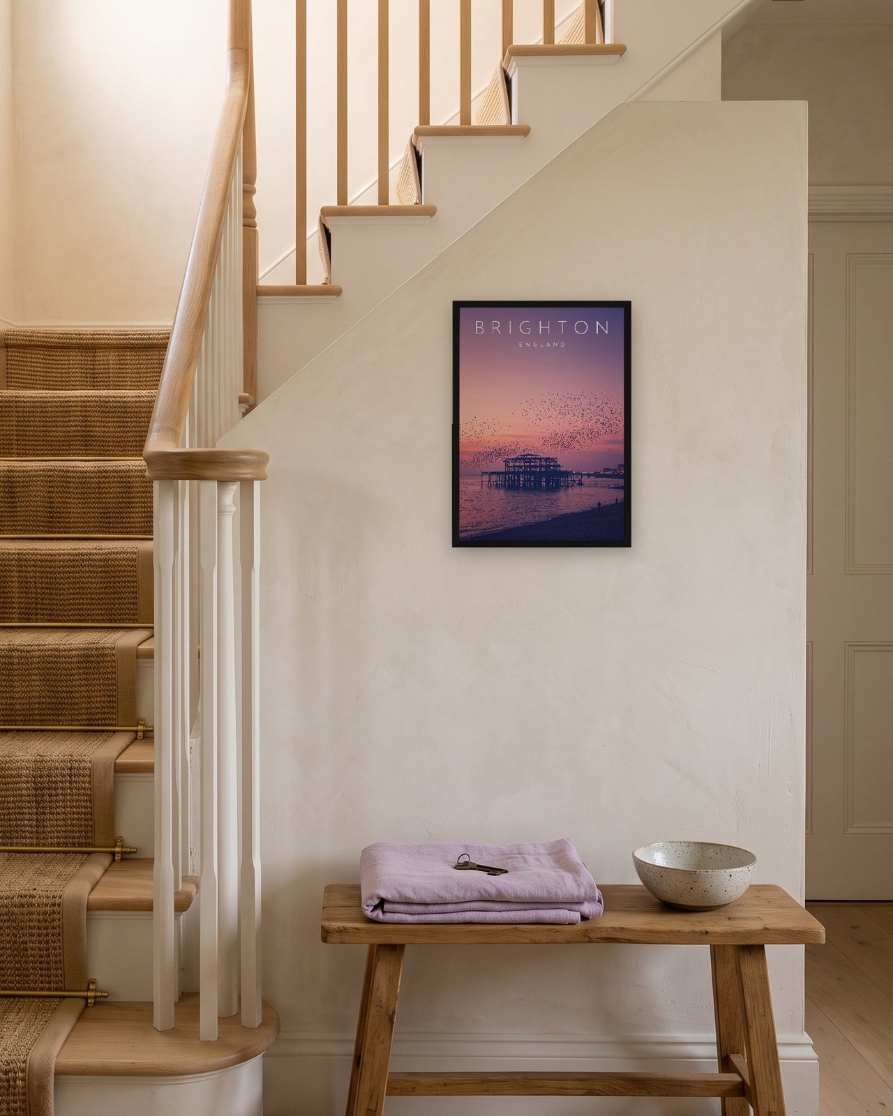 Brighton West Pier at Sunset print, black frame A3 on a staircase wall