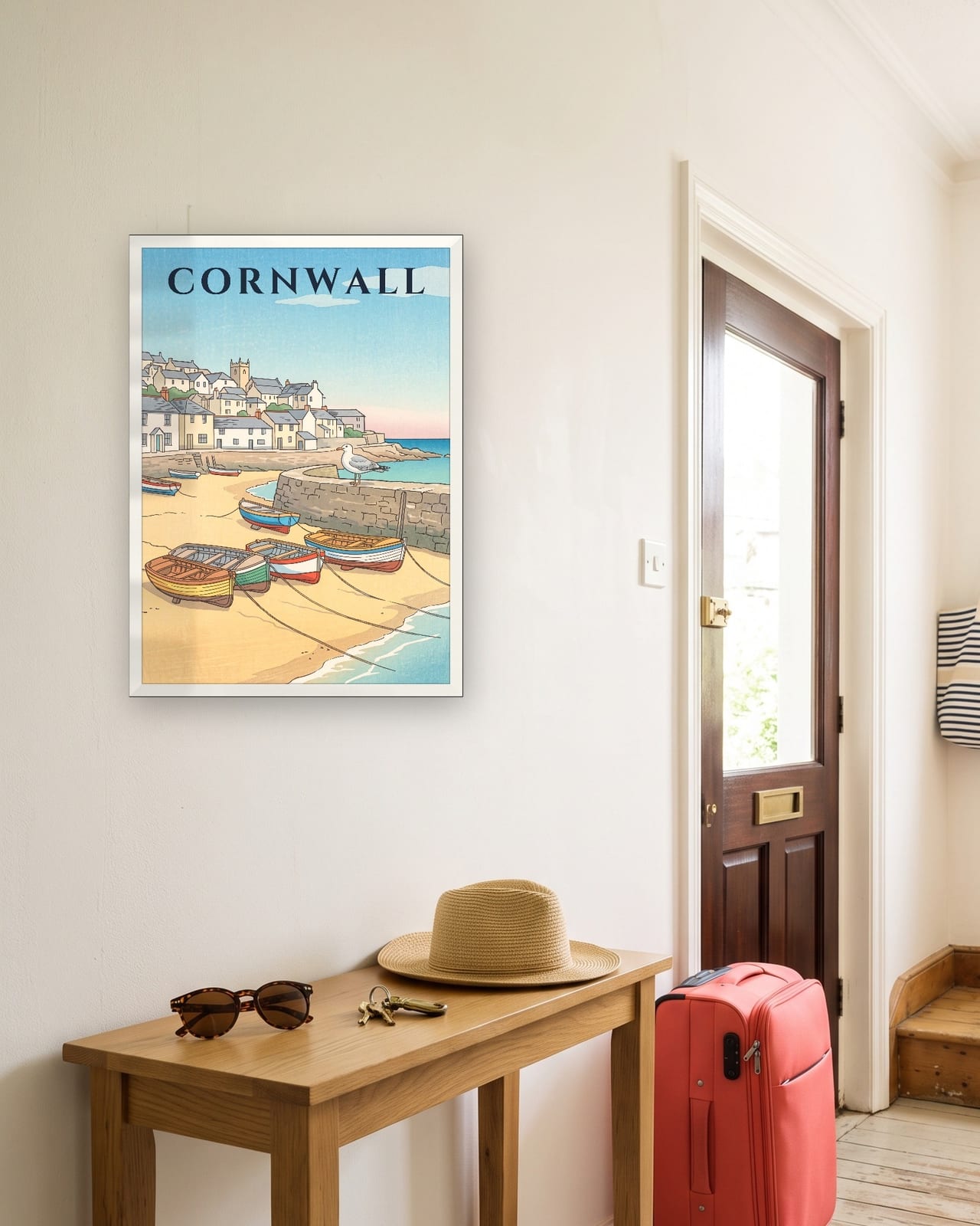 Cornwall St Ives Harbour print, white frame A3 in a sunny hallway with a packed suitcase