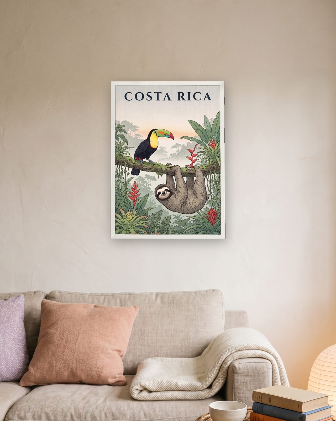 Costa Rica Toucan and Sloth print, white frame A3 above a linen sofa