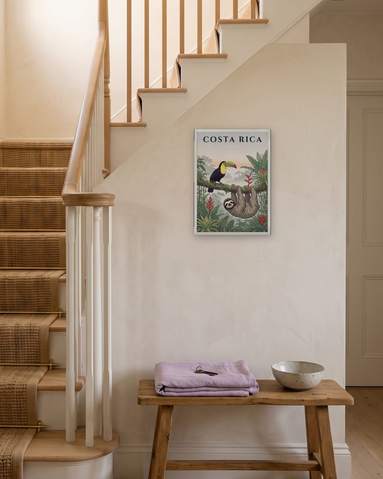 Costa Rica Toucan and Sloth print, white frame A3 on a staircase wall