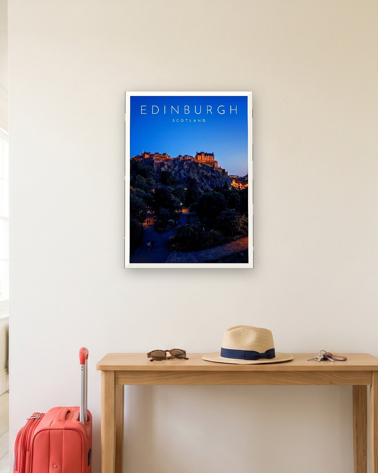 Edinburgh Castle at Blue Hour print, white frame A3 in a hallway with a packed suitcase