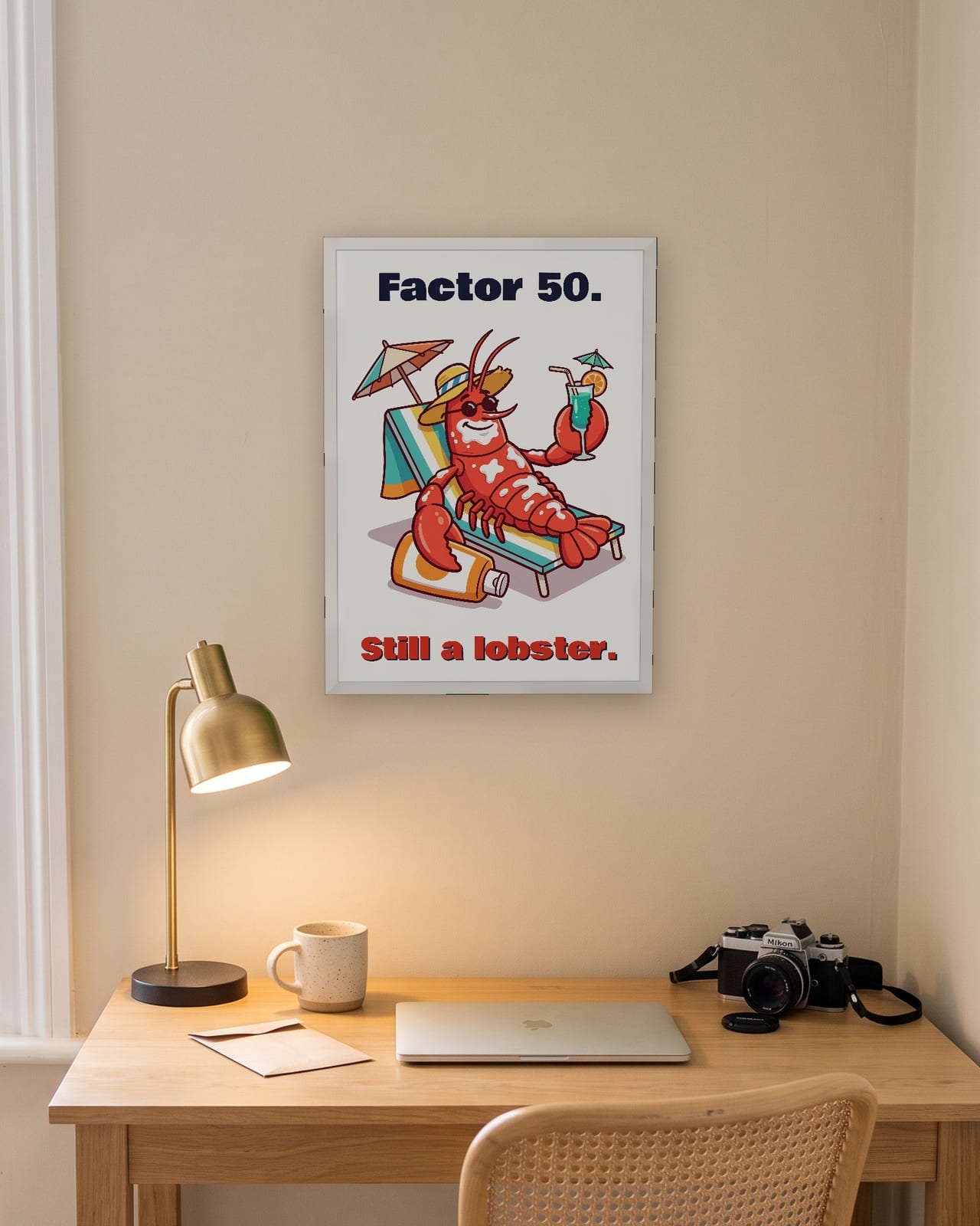 Factor 50 Still a Lobster print, white frame A3 above a home office desk