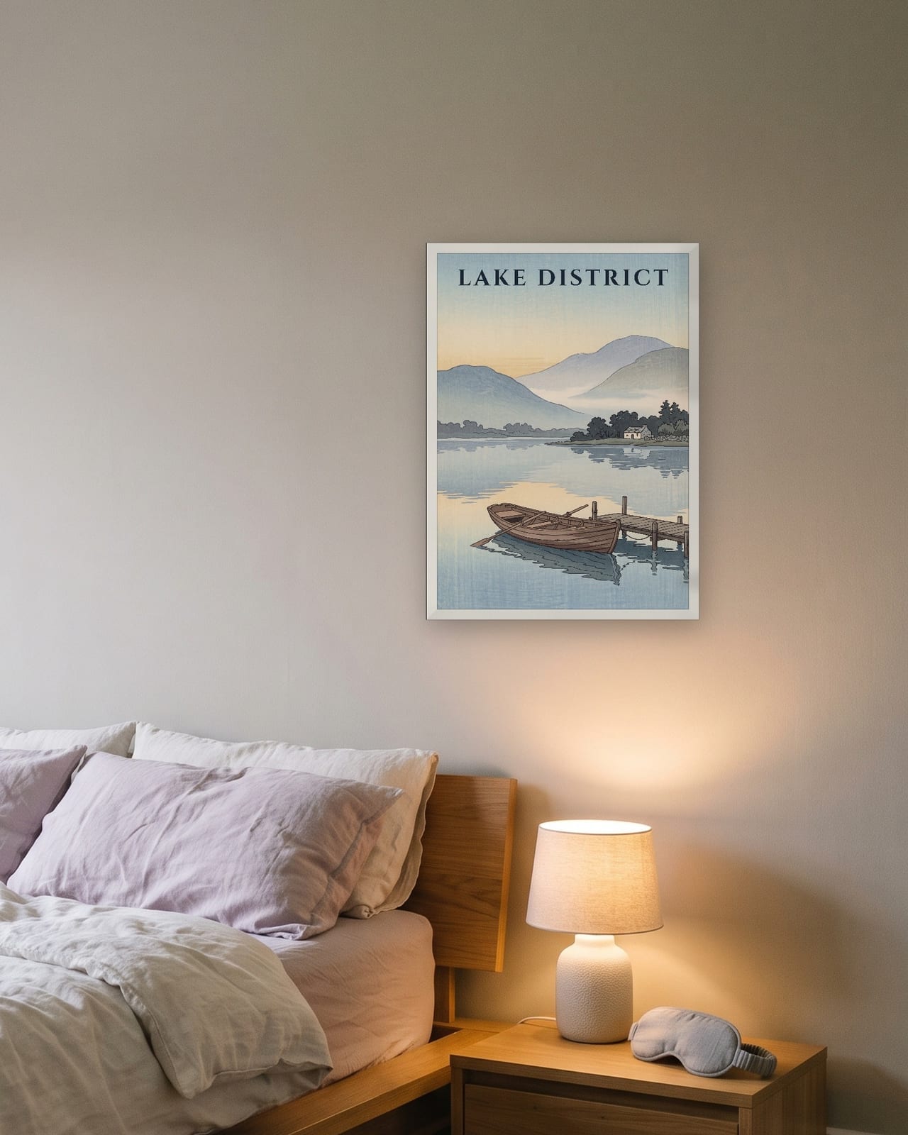 Lake District Rowing Boat print, white frame A3 above a bedside table