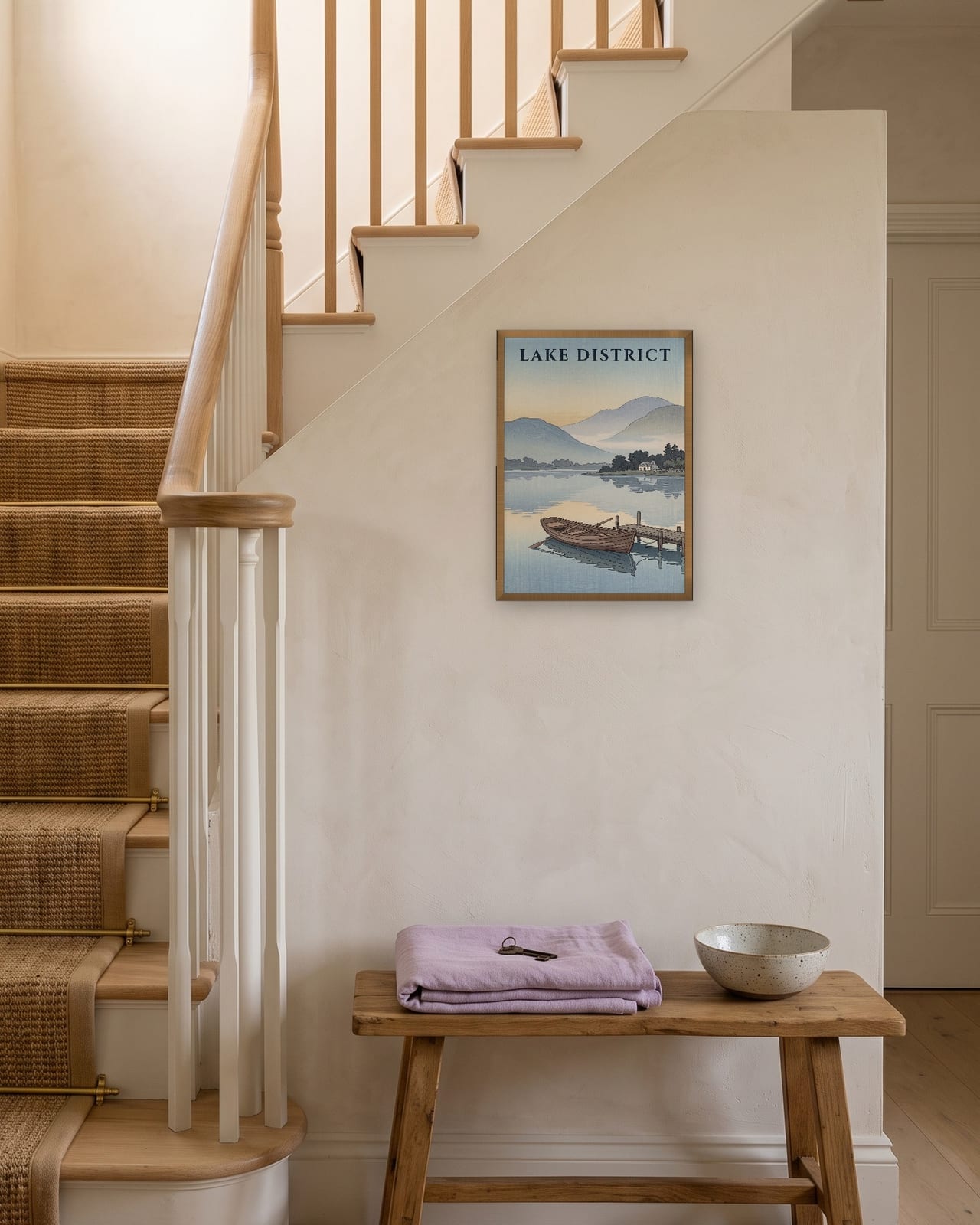 Lake District Rowing Boat print, natural oak frame A3 on a staircase wall