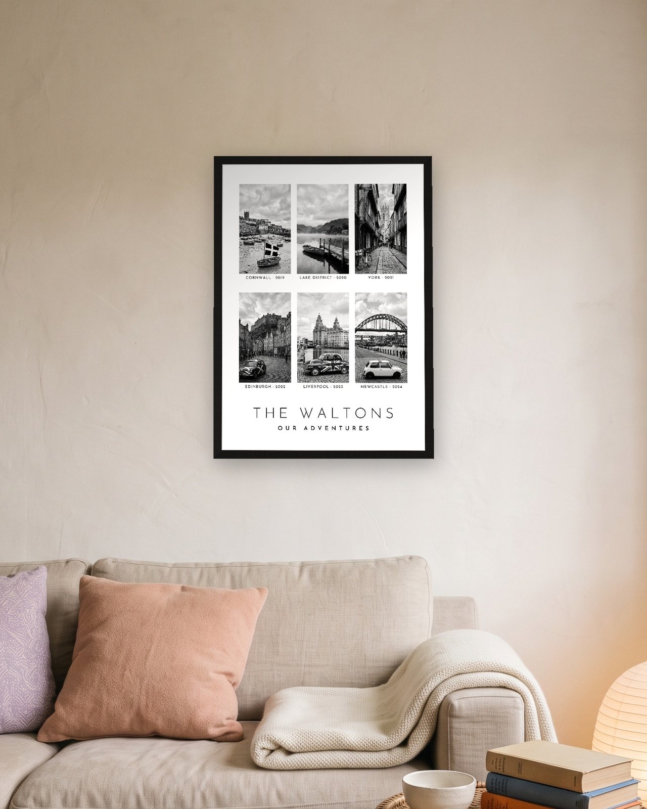Our Family Adventures print in a black A3 frame above a linen sofa, six UK trips for The Waltons