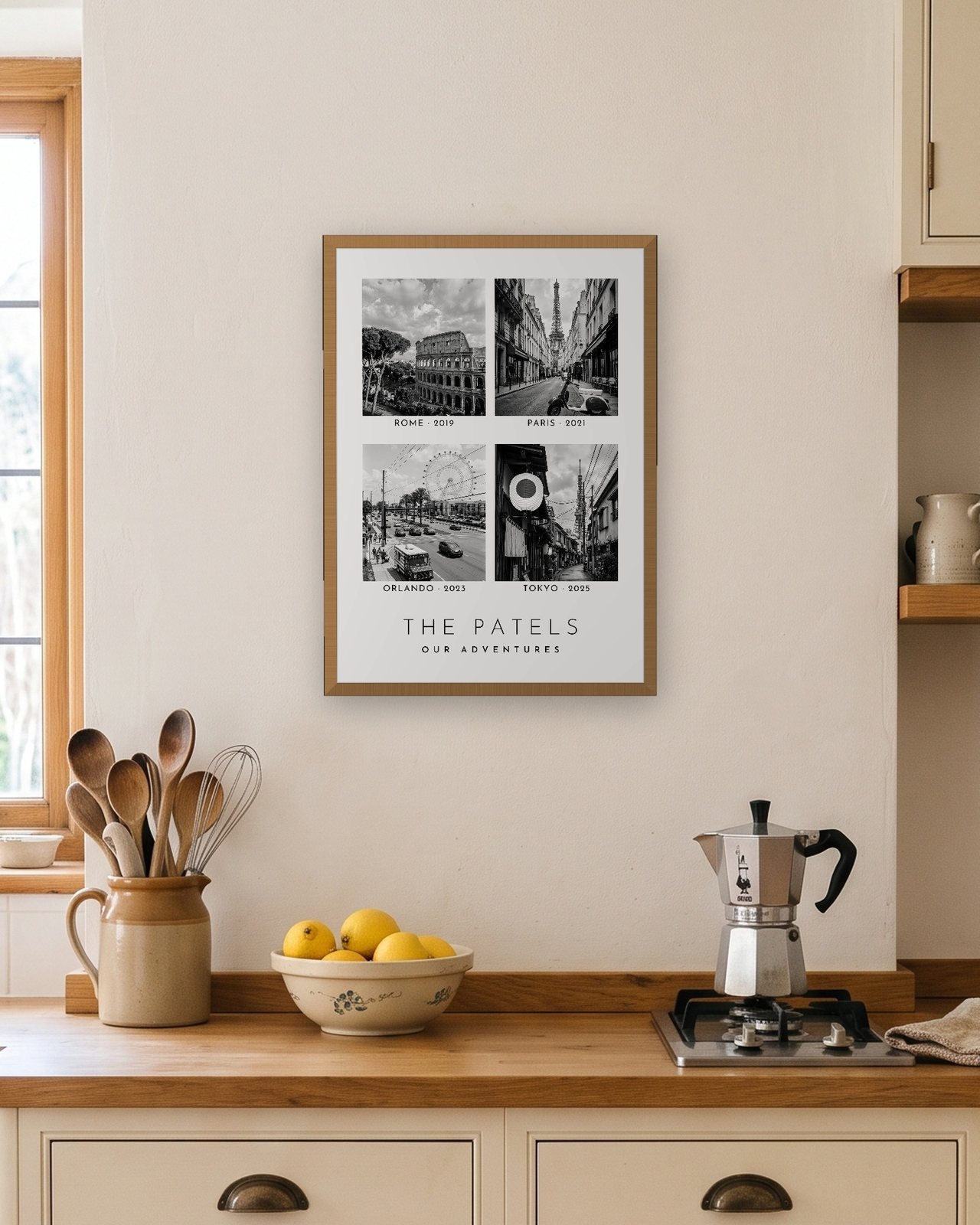 Our Family Adventures print in a natural oak A3 frame in a bright kitchen, four trips abroad for The Patels