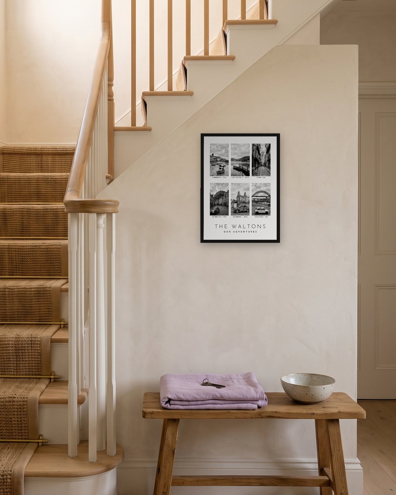 Our Family Adventures print in a black A3 frame on a staircase wall