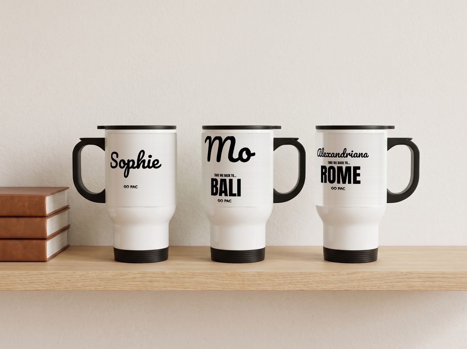 Three white travel mugs with three made-up names