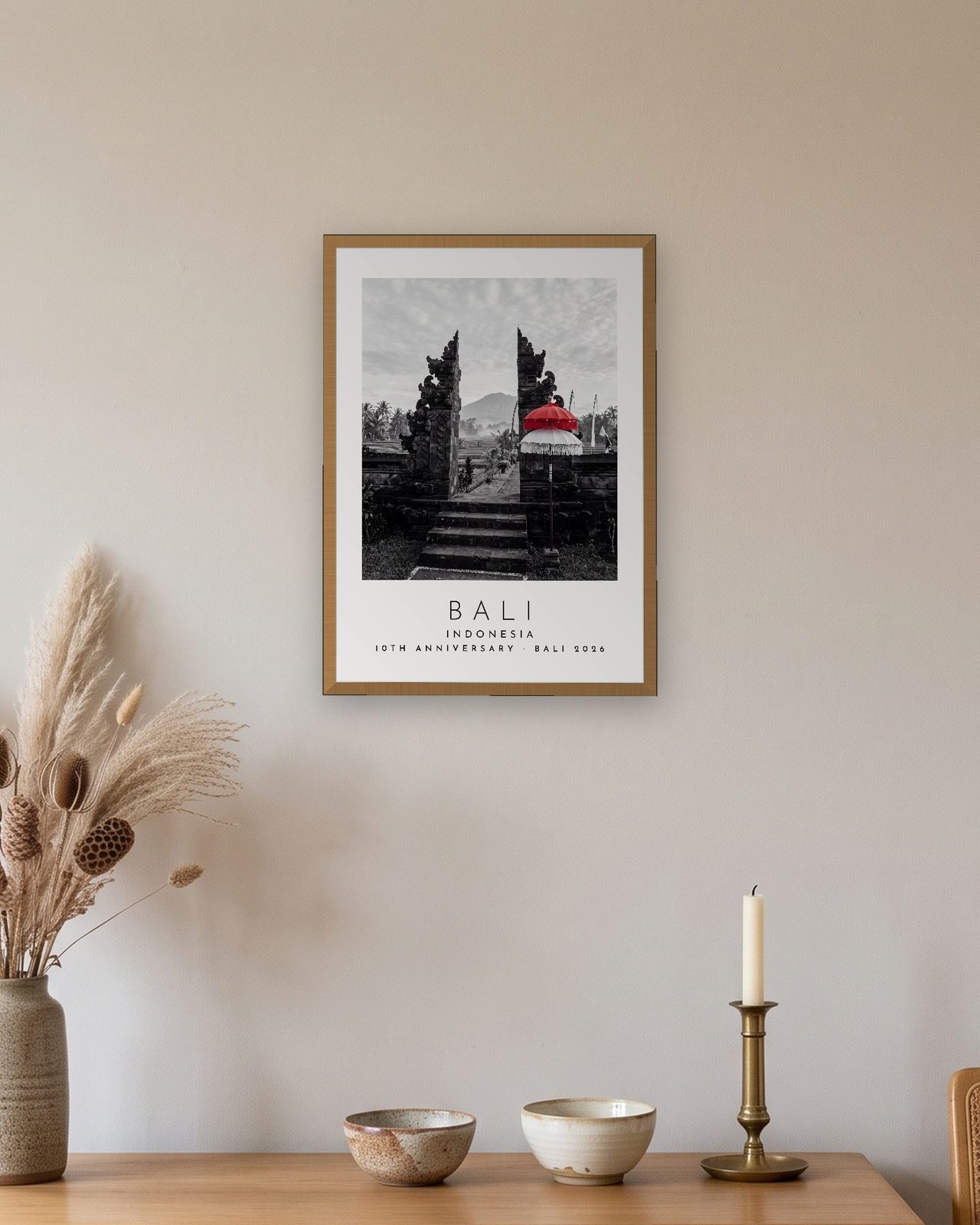 Our Trip Bali print: natural oak frame A3 above an oak sideboard, personalised 10TH ANNIVERSARY · BALI 2026