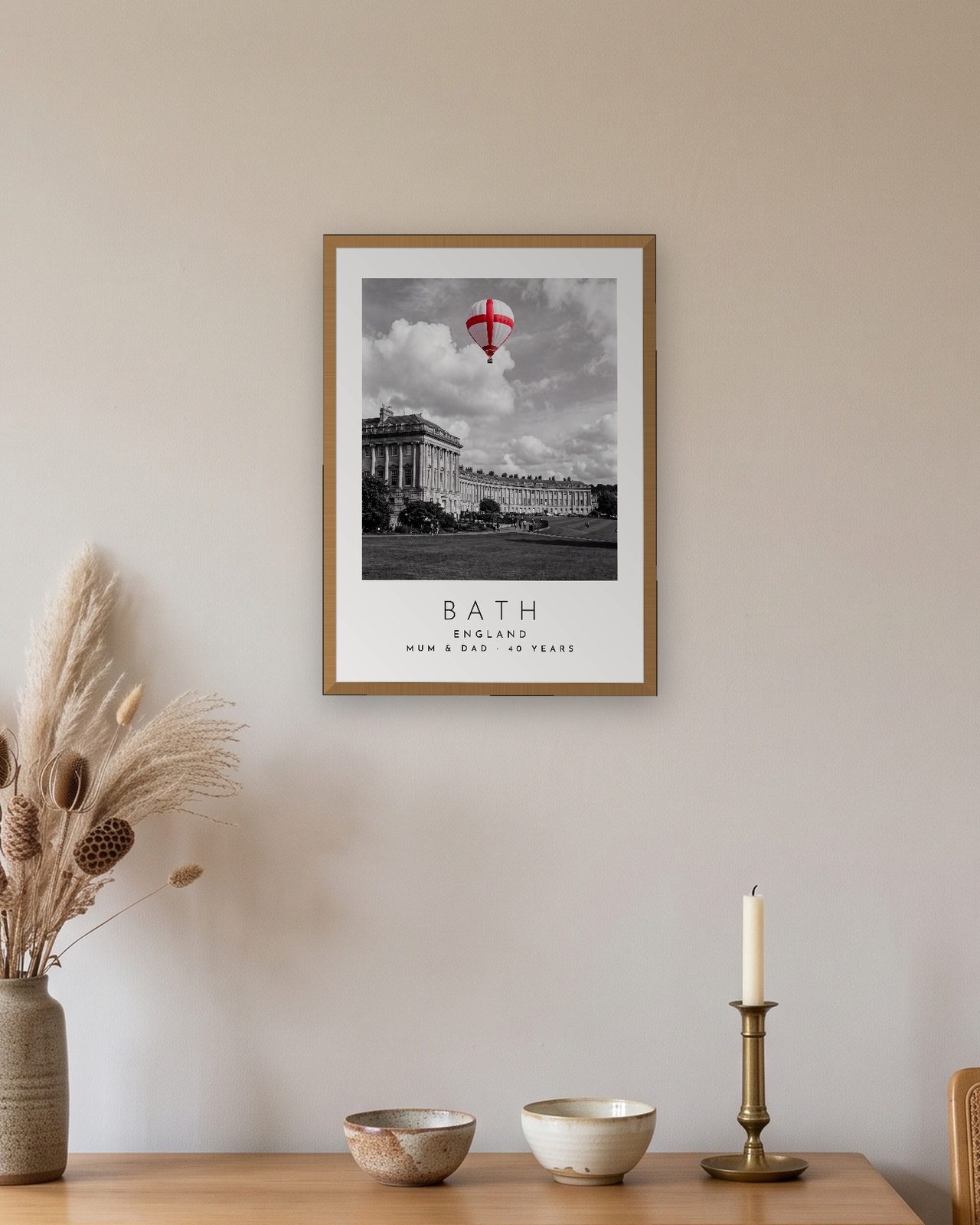 Our Trip Bath print: natural oak frame A3 above an oak sideboard, personalised MUM & DAD · 40 YEARS