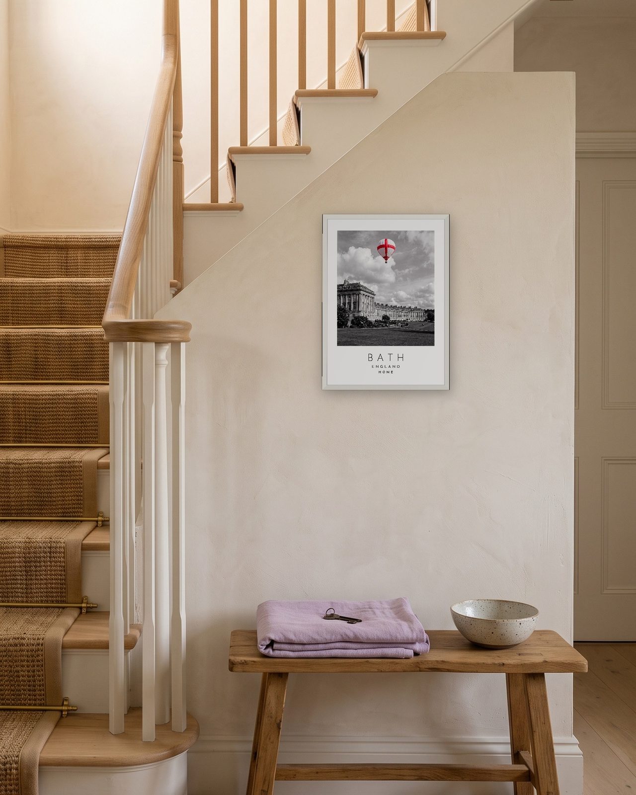 Our Trip Bath print: white frame A3 on a staircase wall, personalised HOME