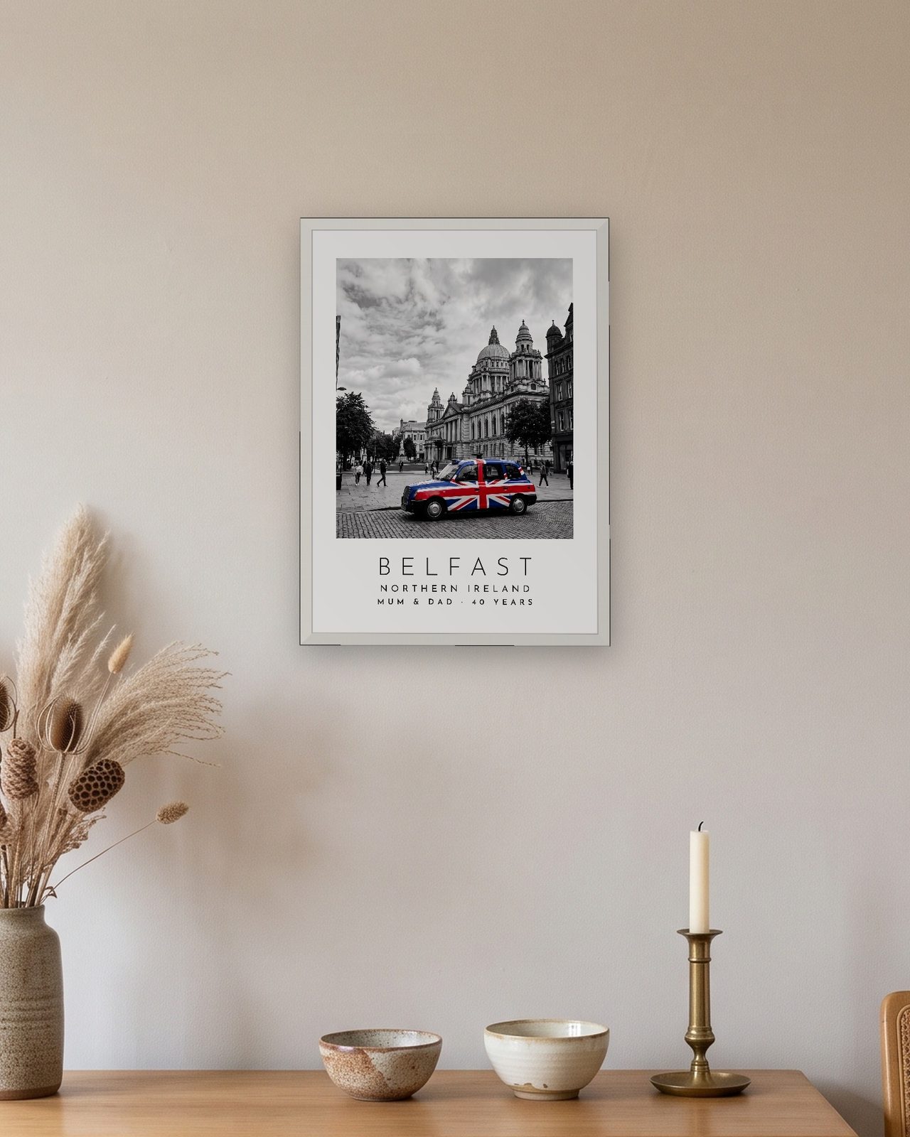 Our Trip Belfast print: white frame A3 above an oak sideboard, personalised MUM & DAD · 40 YEARS