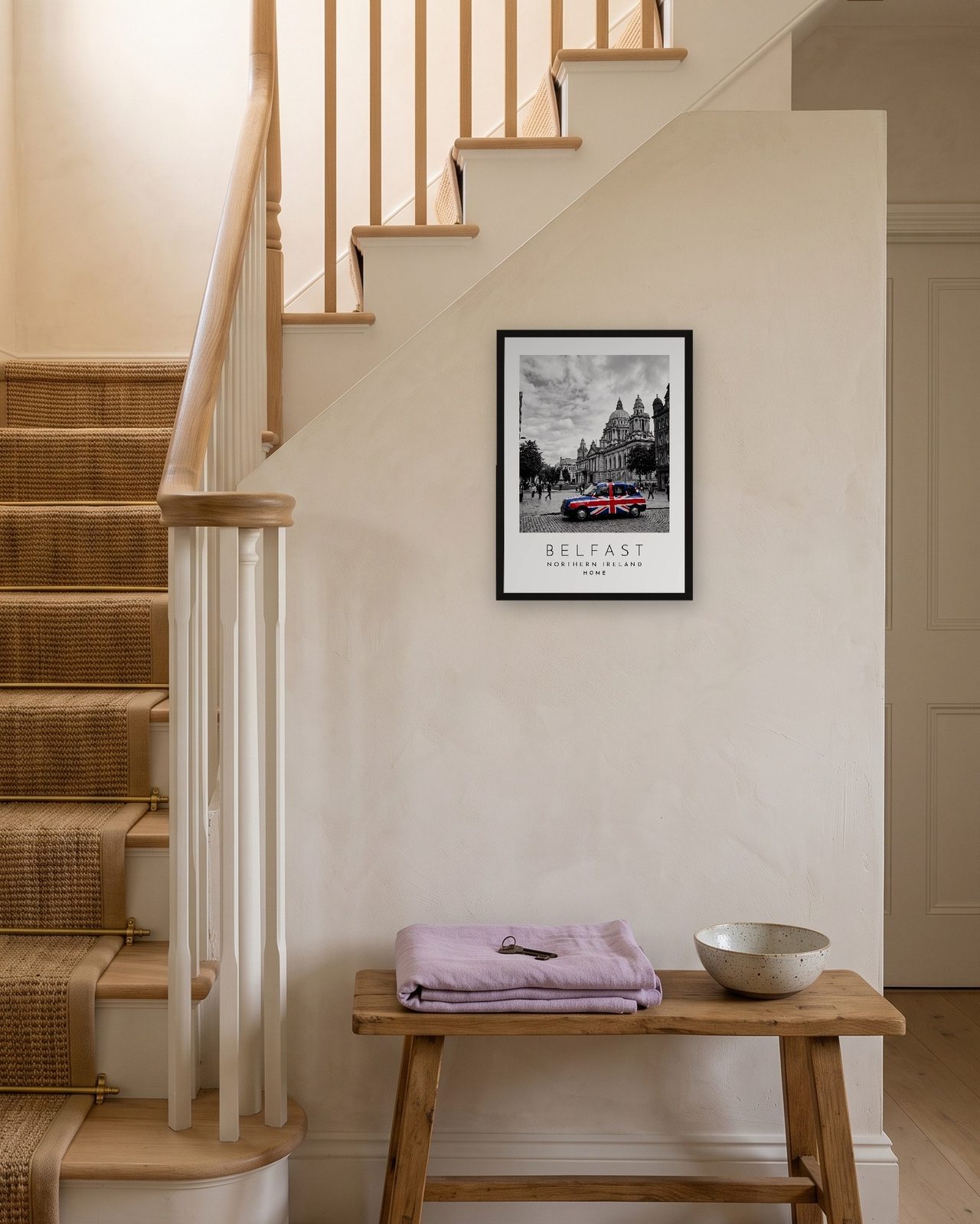 Our Trip Belfast print: black frame A3 on a staircase wall, personalised HOME