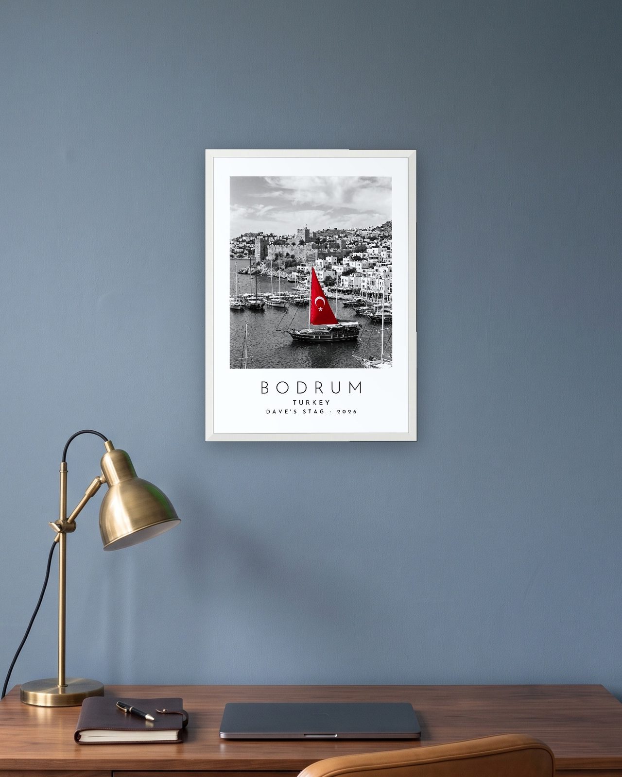 Our Trip Bodrum print: white frame A3 in a slate-blue study, personalised DAVE'S STAG · 2026