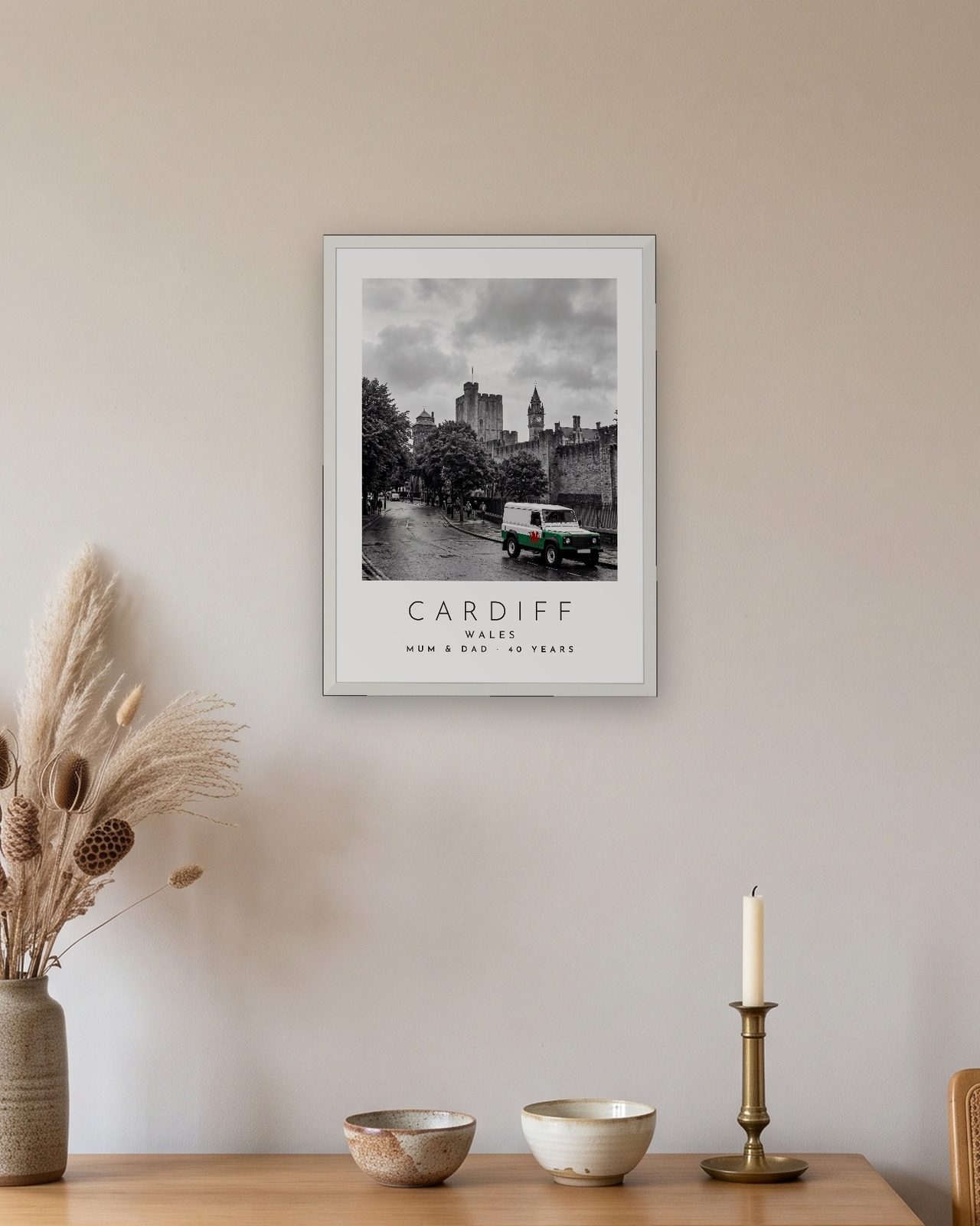 Our Trip Cardiff print: white frame A3 above an oak sideboard, personalised MUM & DAD · 40 YEARS