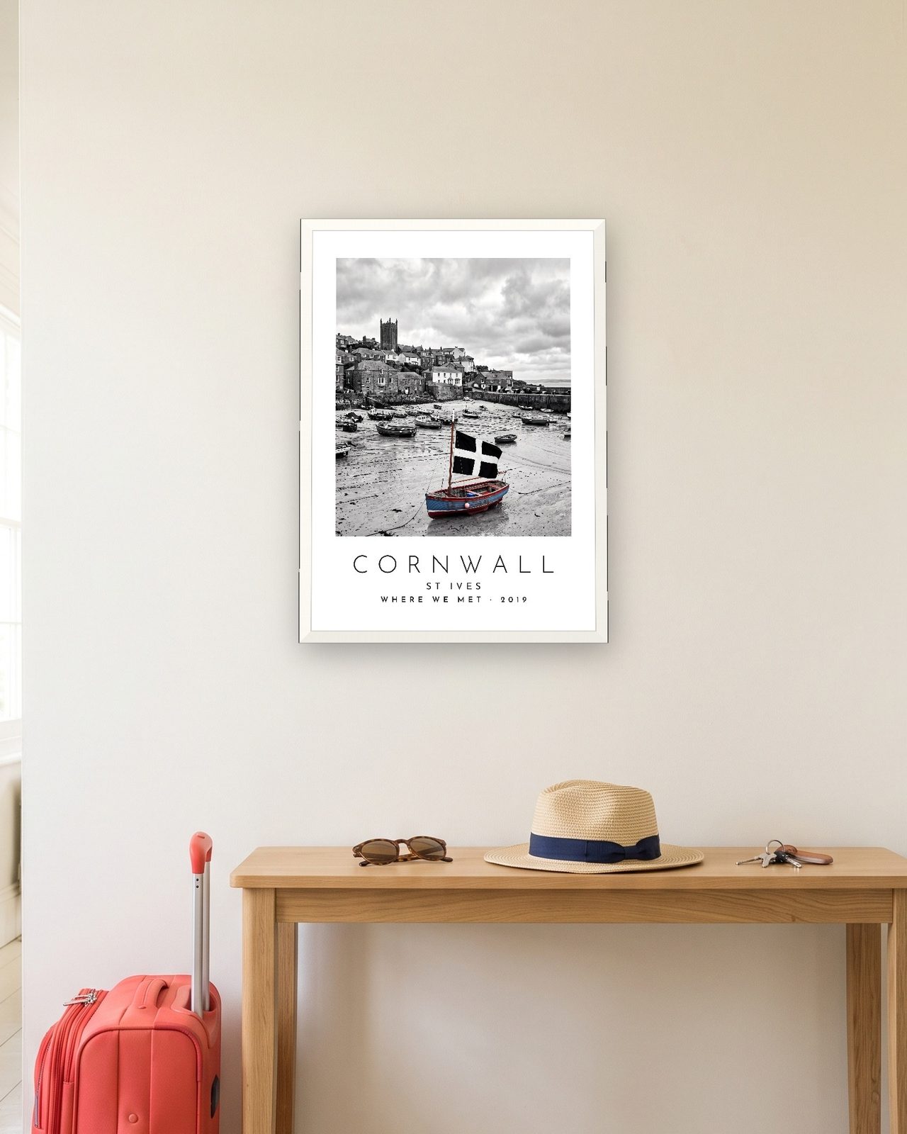 Our Trip Cornwall, St Ives print: white frame A3 in a hallway with a packed suitcase, personalised WHERE WE MET · 2019