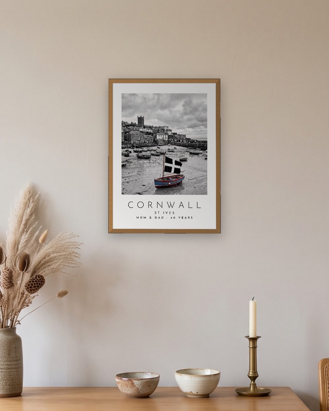 Our Trip Cornwall, St Ives print: natural oak frame A3 above an oak sideboard, personalised MUM & DAD · 40 YEARS