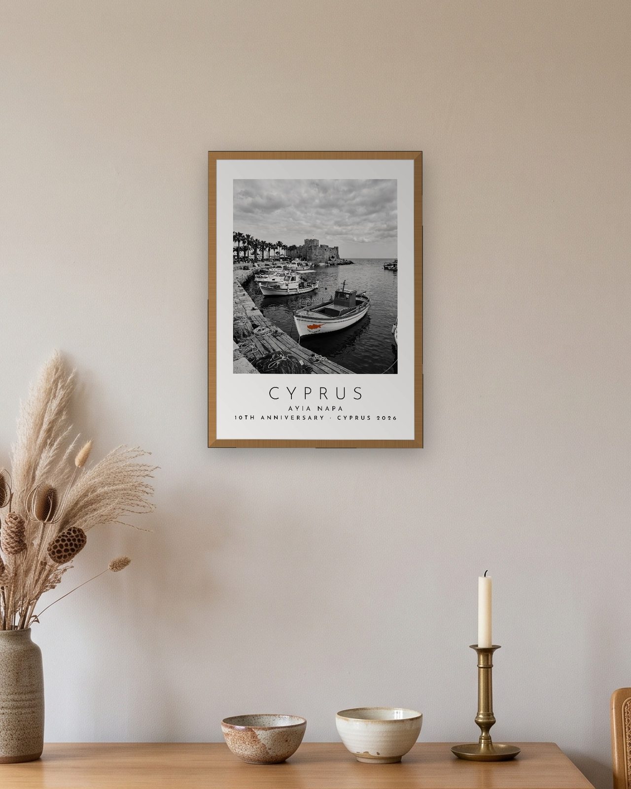Our Trip Cyprus, Ayia Napa print: natural oak frame A3 above an oak sideboard, personalised 10TH ANNIVERSARY · CYPRUS 2026