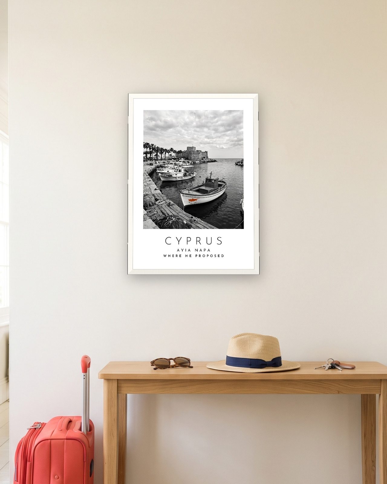 Our Trip Cyprus, Ayia Napa print: white frame A3 in a hallway with a packed suitcase, personalised WHERE HE PROPOSED