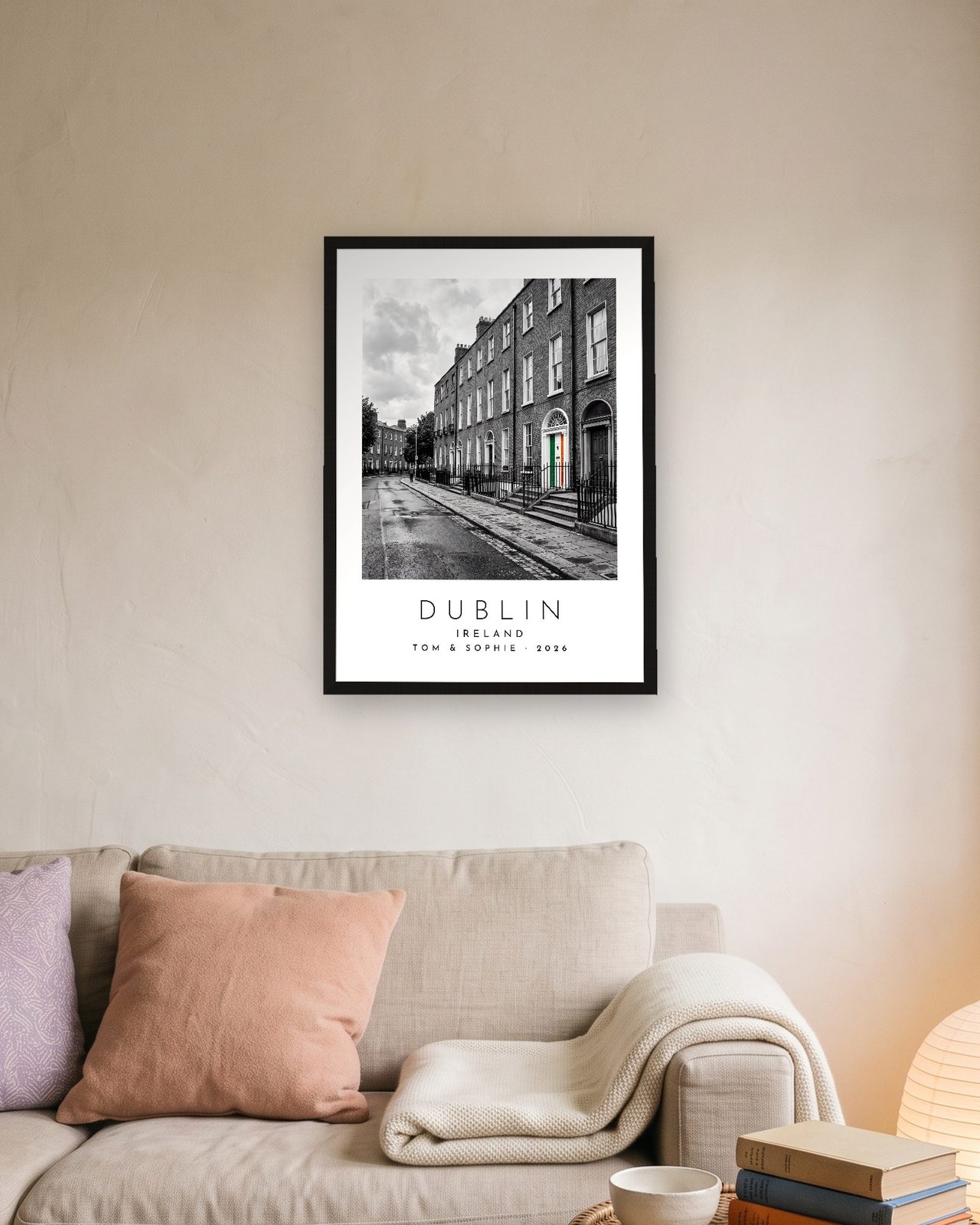 Our Trip Dublin print: black frame A3 above a linen sofa, personalised TOM & SOPHIE · 2026