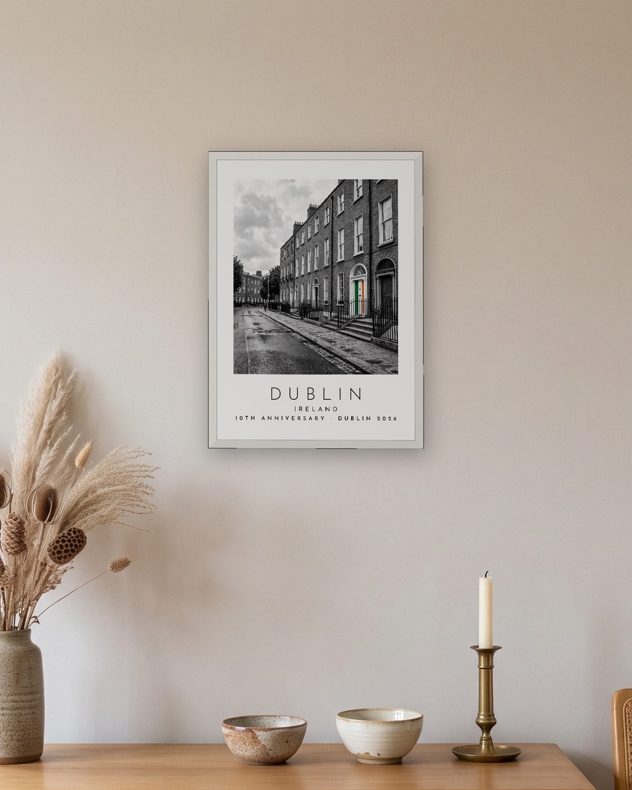 Our Trip Dublin print: white frame A3 above an oak sideboard, personalised 10TH ANNIVERSARY · DUBLIN 2026