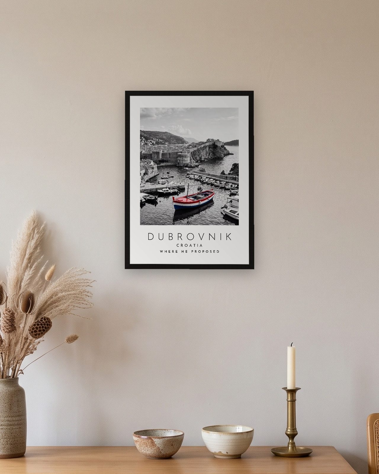 Our Trip Dubrovnik print: black frame A3 above an oak sideboard, personalised WHERE HE PROPOSED