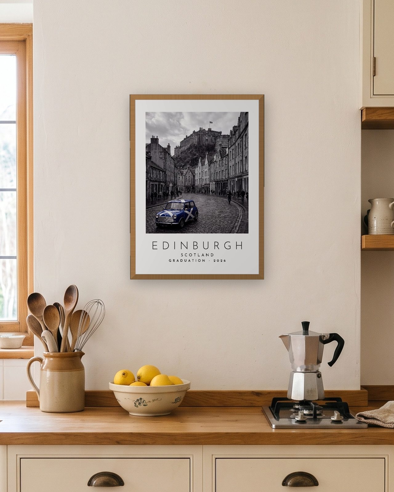 Our Trip Edinburgh print: natural oak frame A3 in a bright kitchen, personalised GRADUATION · 2026