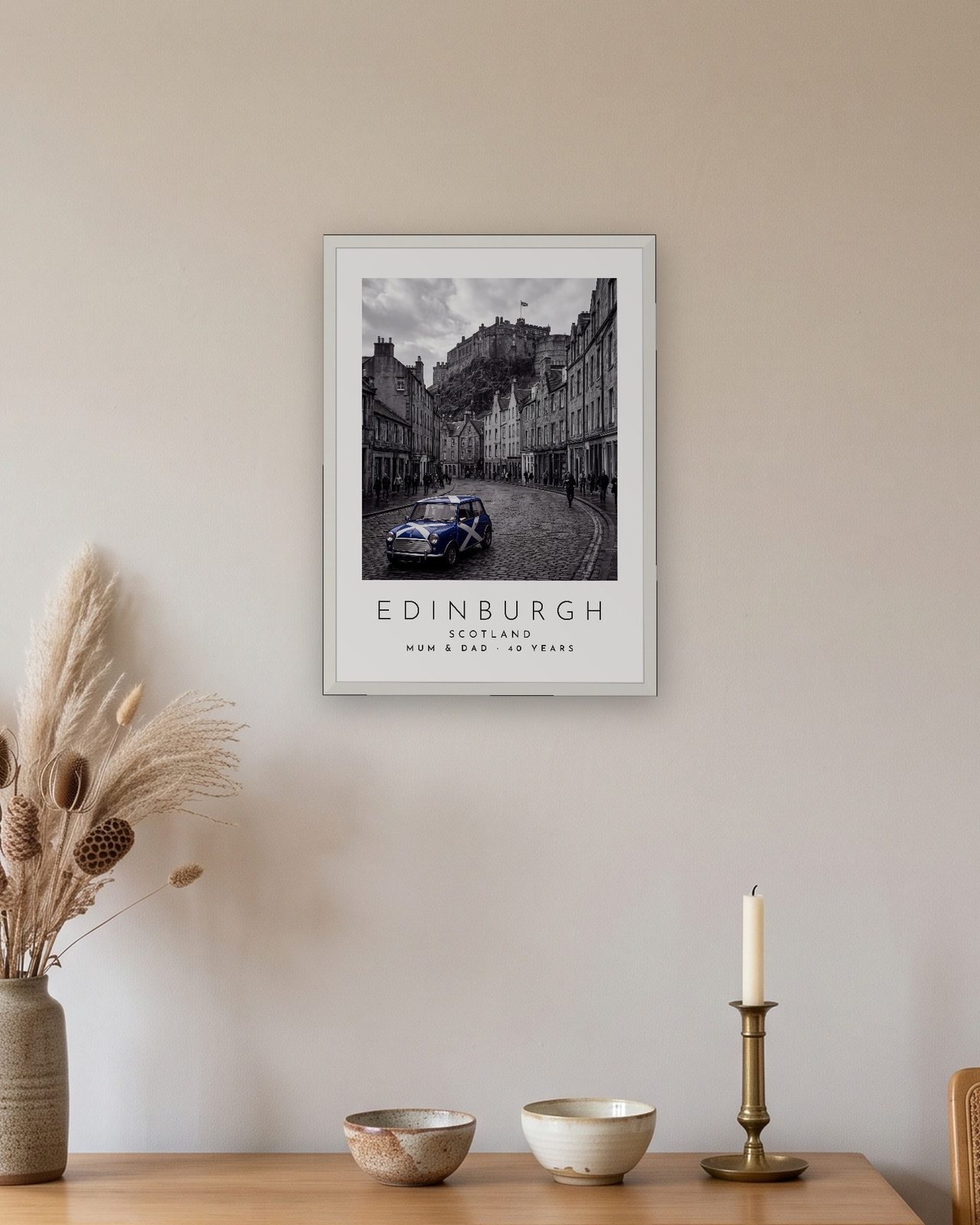 Our Trip Edinburgh print in a white frame above a table with ceramic bowls and a candle, personalised MUM & DAD · 40 YEARS