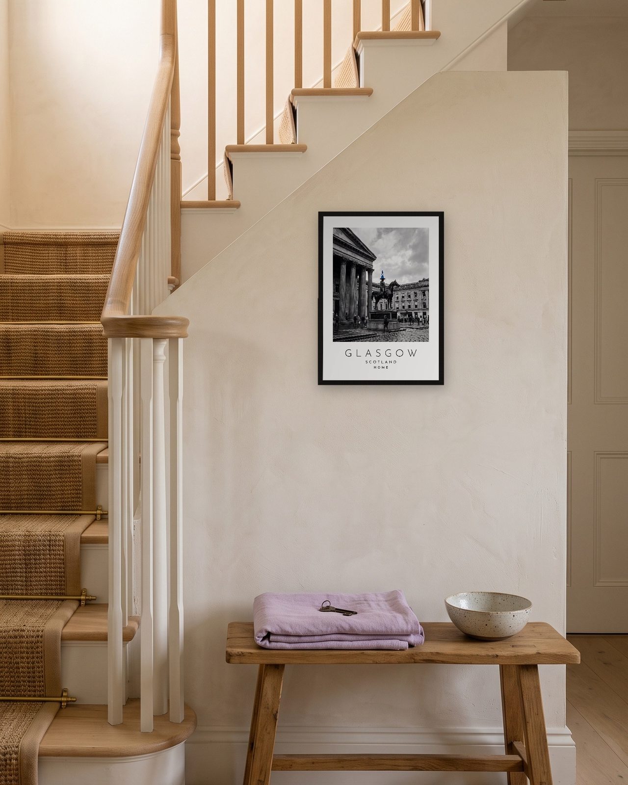 Our Trip Glasgow print: black frame A3 on a staircase wall, personalised HOME