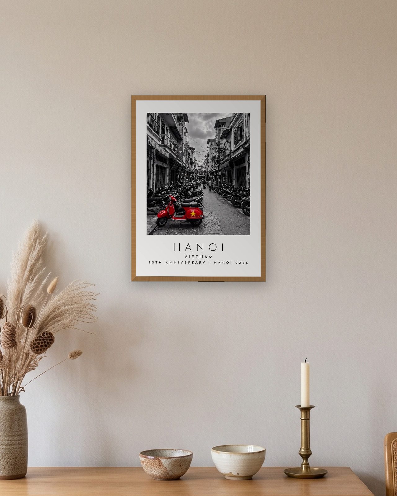 Our Trip Hanoi print: natural oak frame A3 above an oak sideboard, personalised 10TH ANNIVERSARY · HANOI 2026
