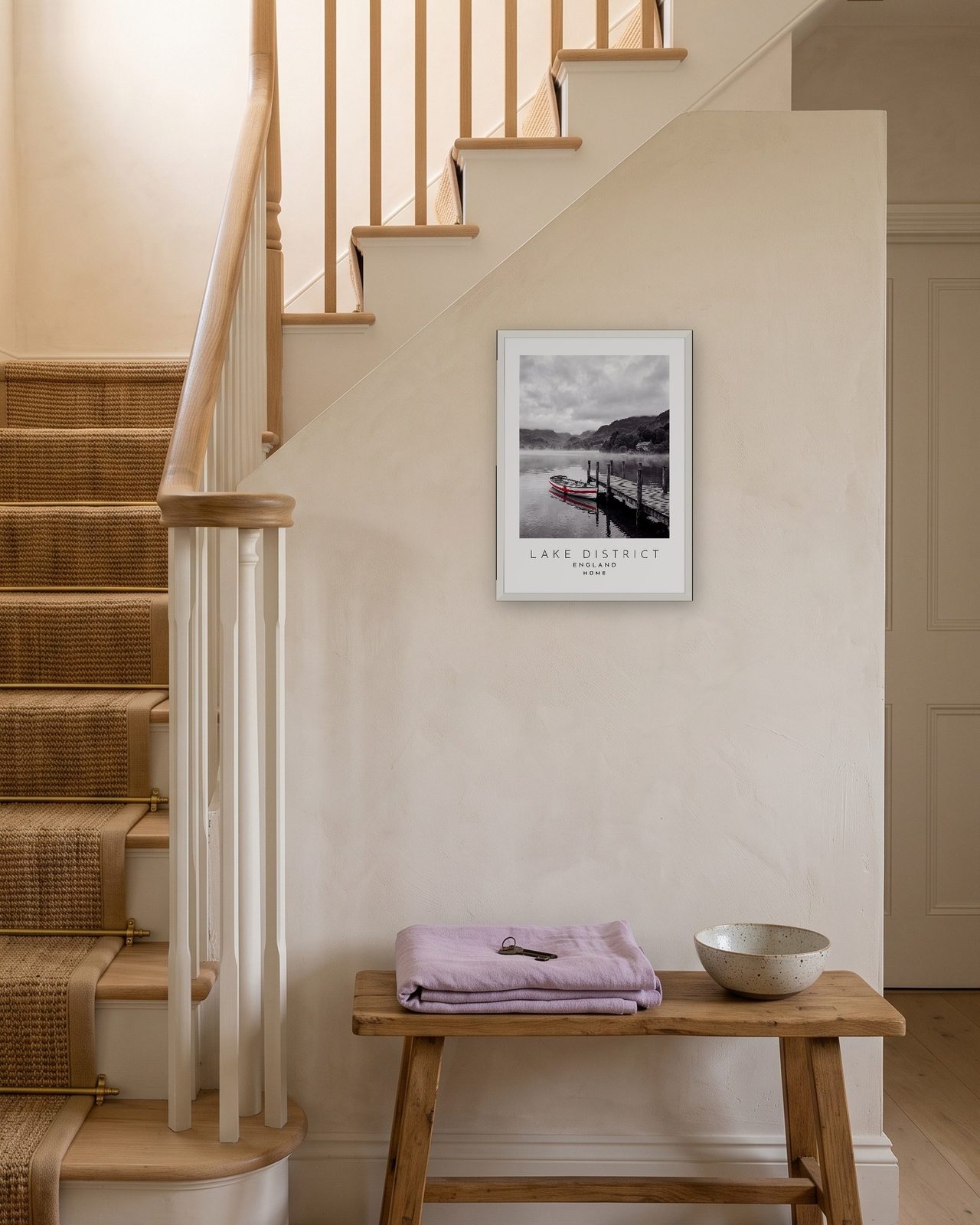 Our Trip Lake District print: white frame A3 on a staircase wall, personalised HOME