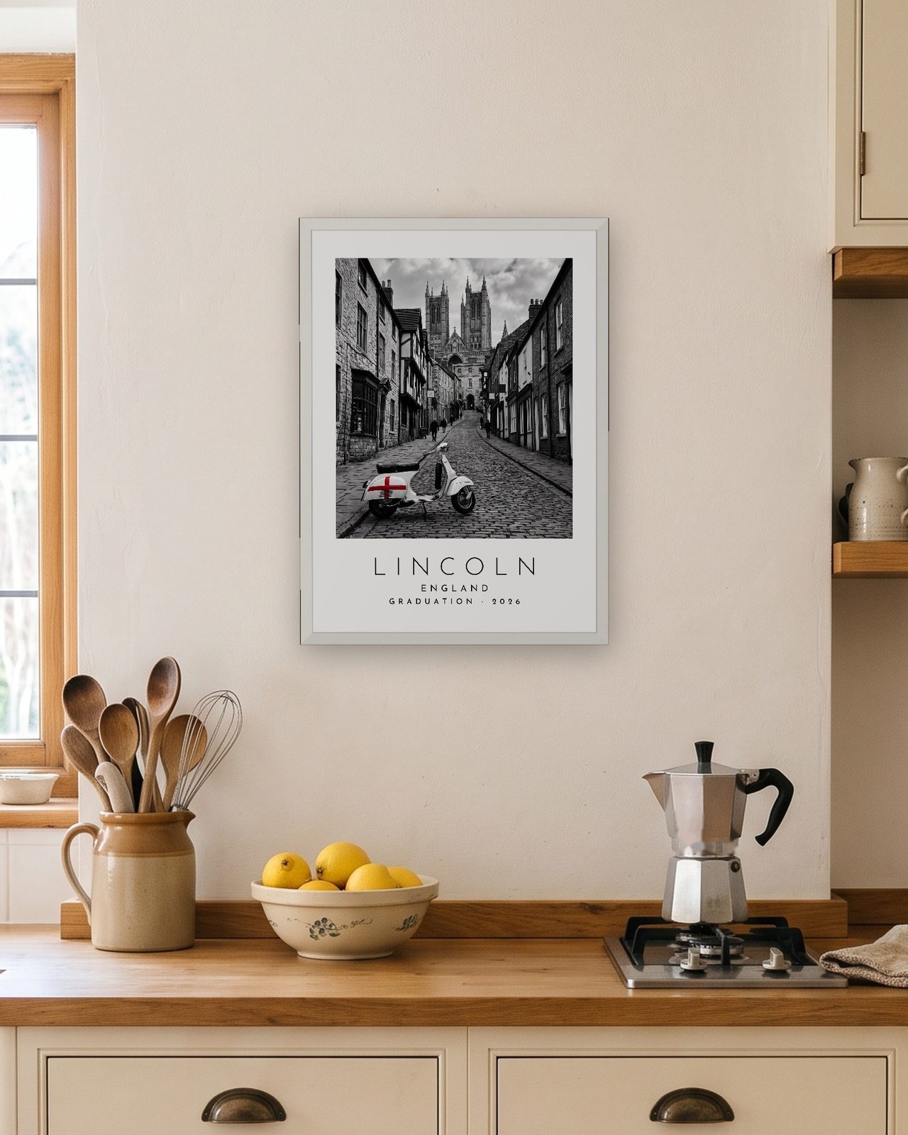Our Trip Lincoln print: white frame A3 in a bright kitchen, personalised GRADUATION · 2026