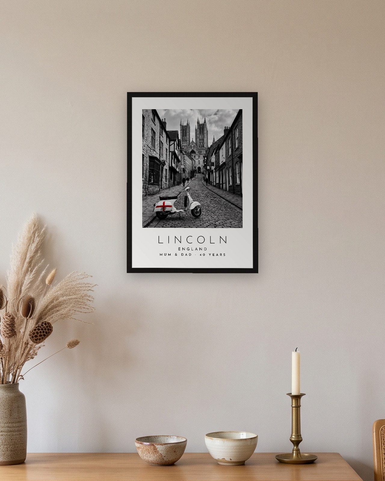 Our Trip Lincoln print: black frame A3 above an oak sideboard, personalised MUM & DAD · 40 YEARS