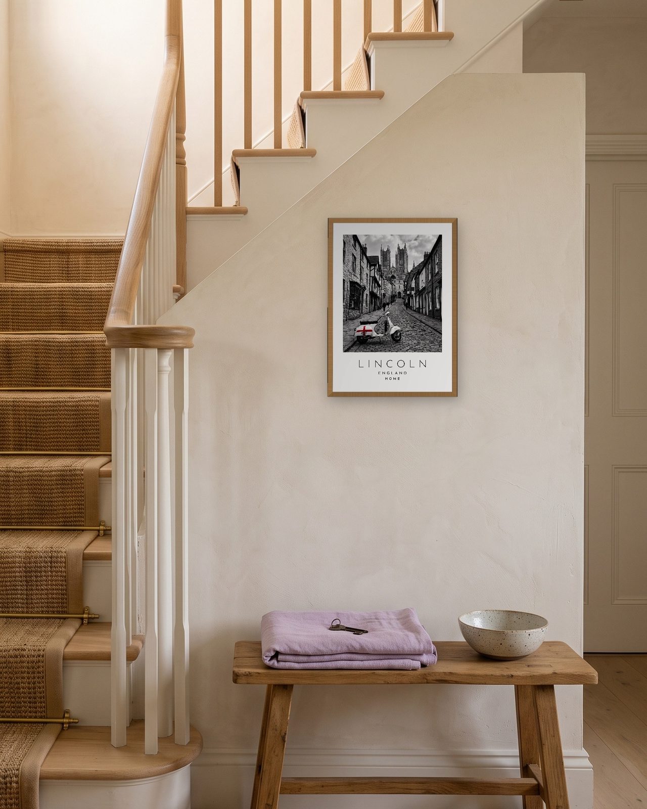 Our Trip Lincoln print: natural oak frame A3 on a staircase wall, personalised HOME