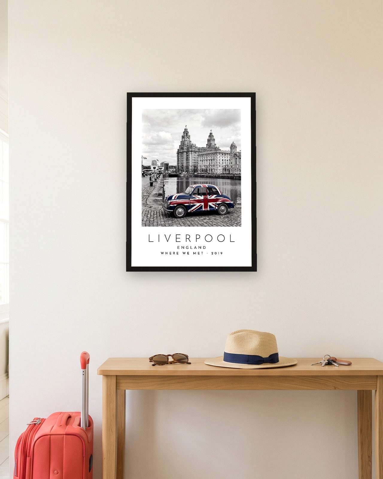 Our Trip Liverpool print: black frame A3 in a hallway with a packed suitcase, personalised WHERE WE MET · 2019