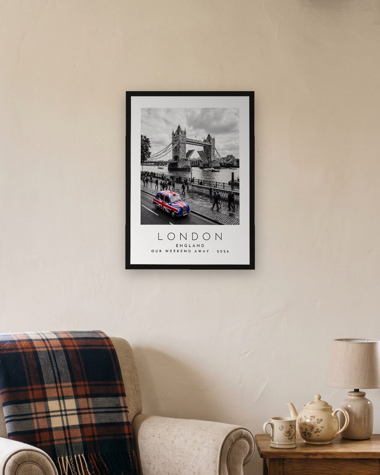 Our Trip London print: black frame A3 in a cottage snug, personalised OUR WEEKEND AWAY · 2026