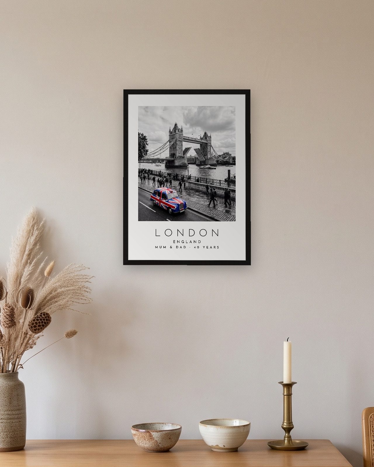 Our Trip London print: black frame A3 above an oak sideboard, personalised MUM & DAD · 40 YEARS