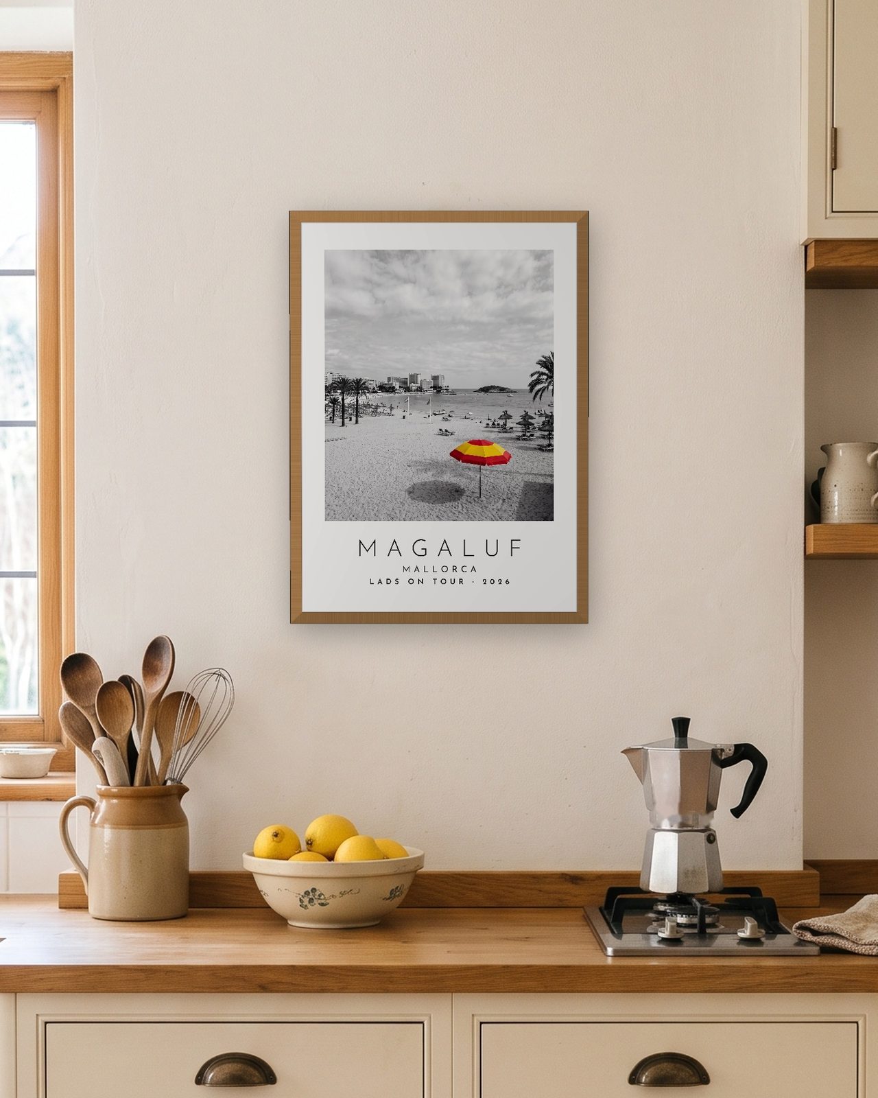 Our Trip Magaluf, Mallorca print: natural oak frame A3 in a bright kitchen, personalised LADS ON TOUR · 2026
