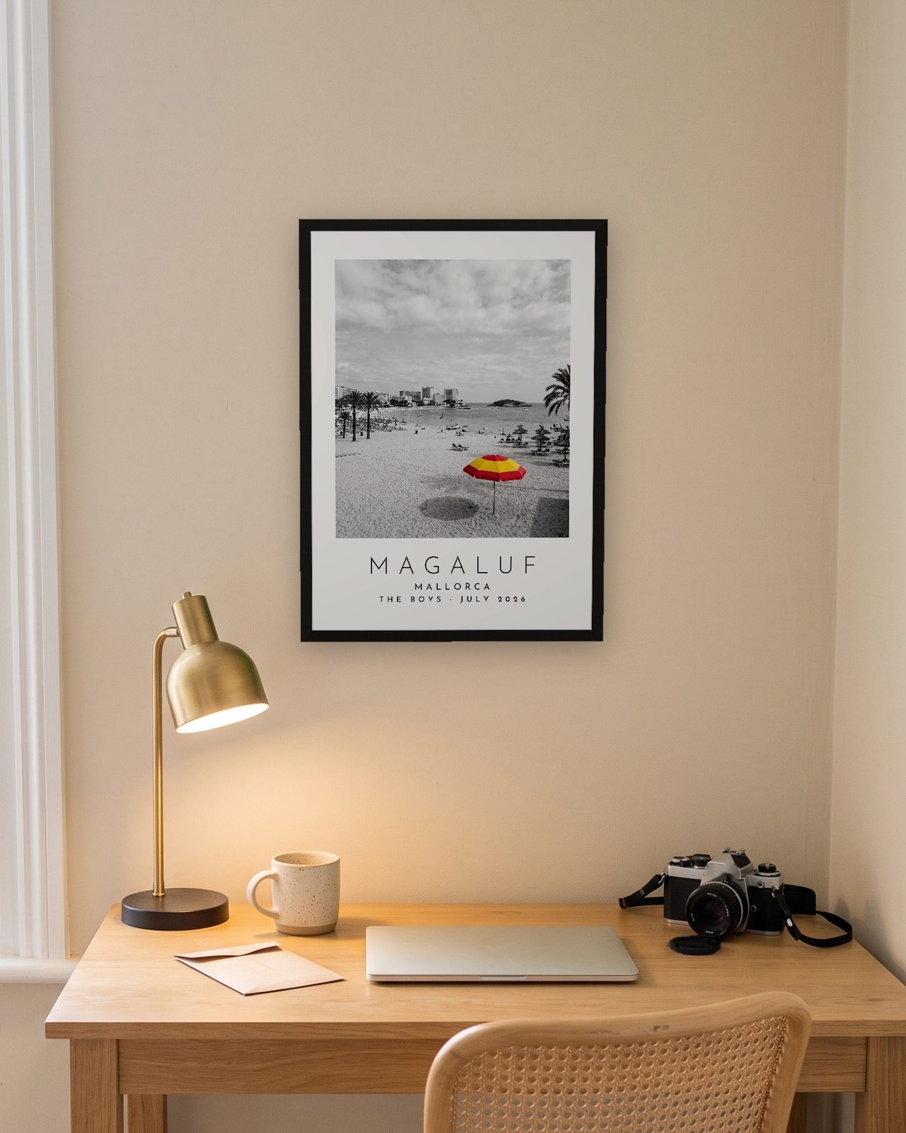 Our Trip Magaluf, Mallorca print: black frame A3 above a home office desk, personalised THE BOYS · JULY 2026