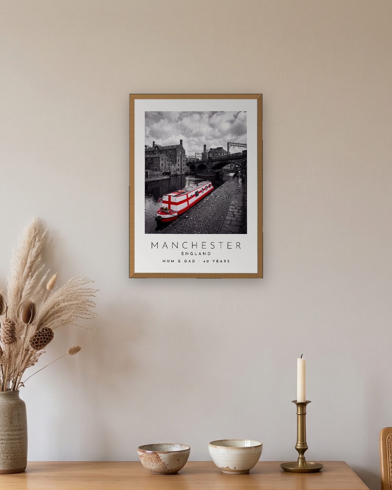 Our Trip Manchester print: natural oak frame A3 above an oak sideboard, personalised MUM & DAD · 40 YEARS