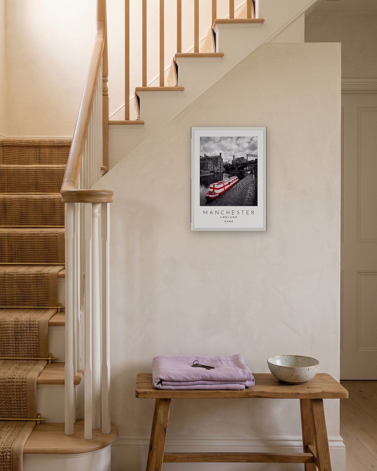Our Trip Manchester print: white frame A3 on a staircase wall, personalised HOME