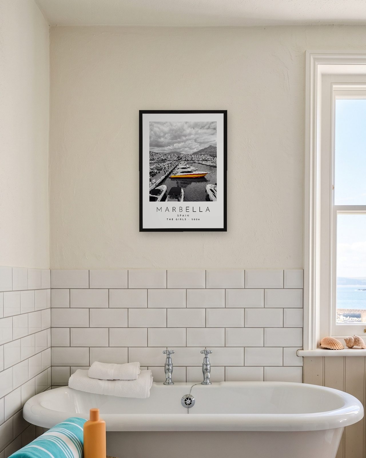Our Trip Marbella print: black frame A3 in a seaside bathroom, personalised THE GIRLS · 2026