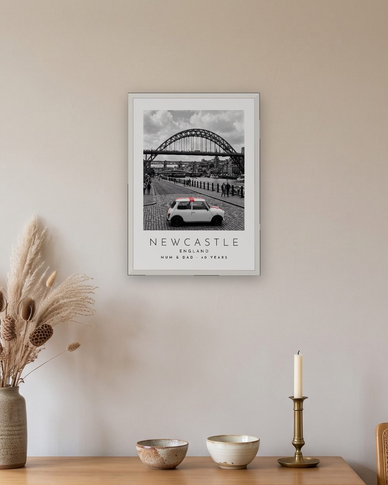 Our Trip Newcastle print: white frame A3 above an oak sideboard, personalised MUM & DAD · 40 YEARS