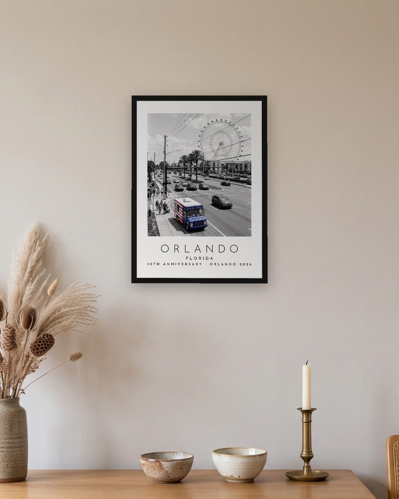 Our Trip Orlando print: black frame A3 above an oak sideboard, personalised 10TH ANNIVERSARY · ORLANDO 2026