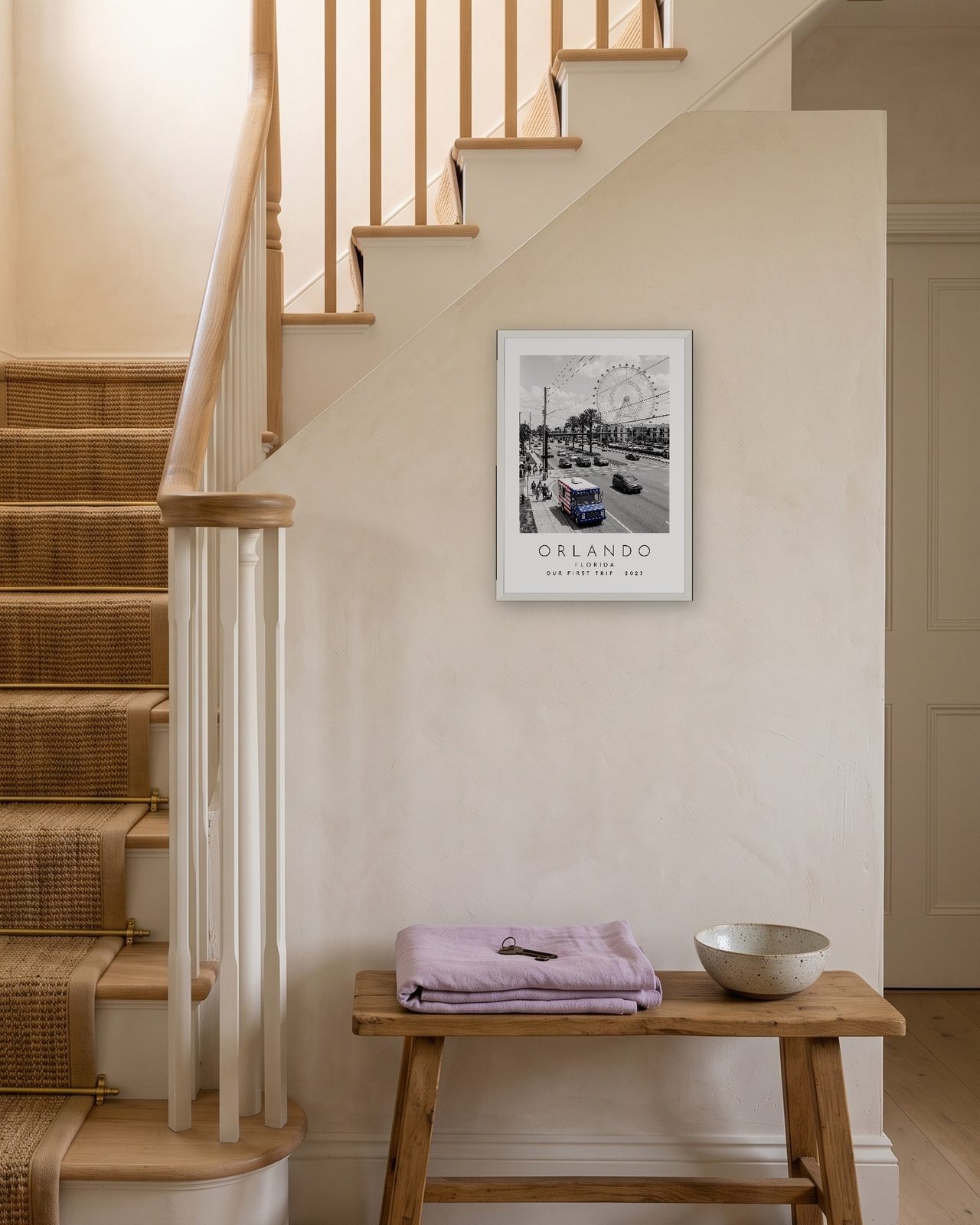 Our Trip Orlando print: white frame A3 on a staircase wall, personalised OUR FIRST TRIP · 2023
