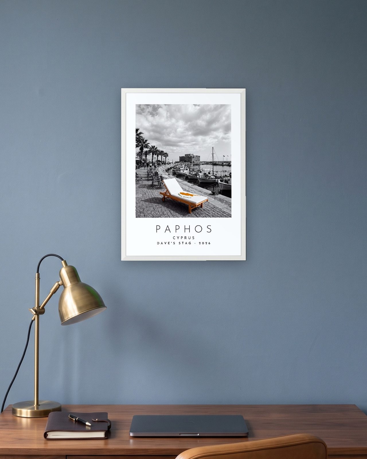 Our Trip Paphos print: white frame A3 in a slate-blue study, personalised DAVE'S STAG · 2026