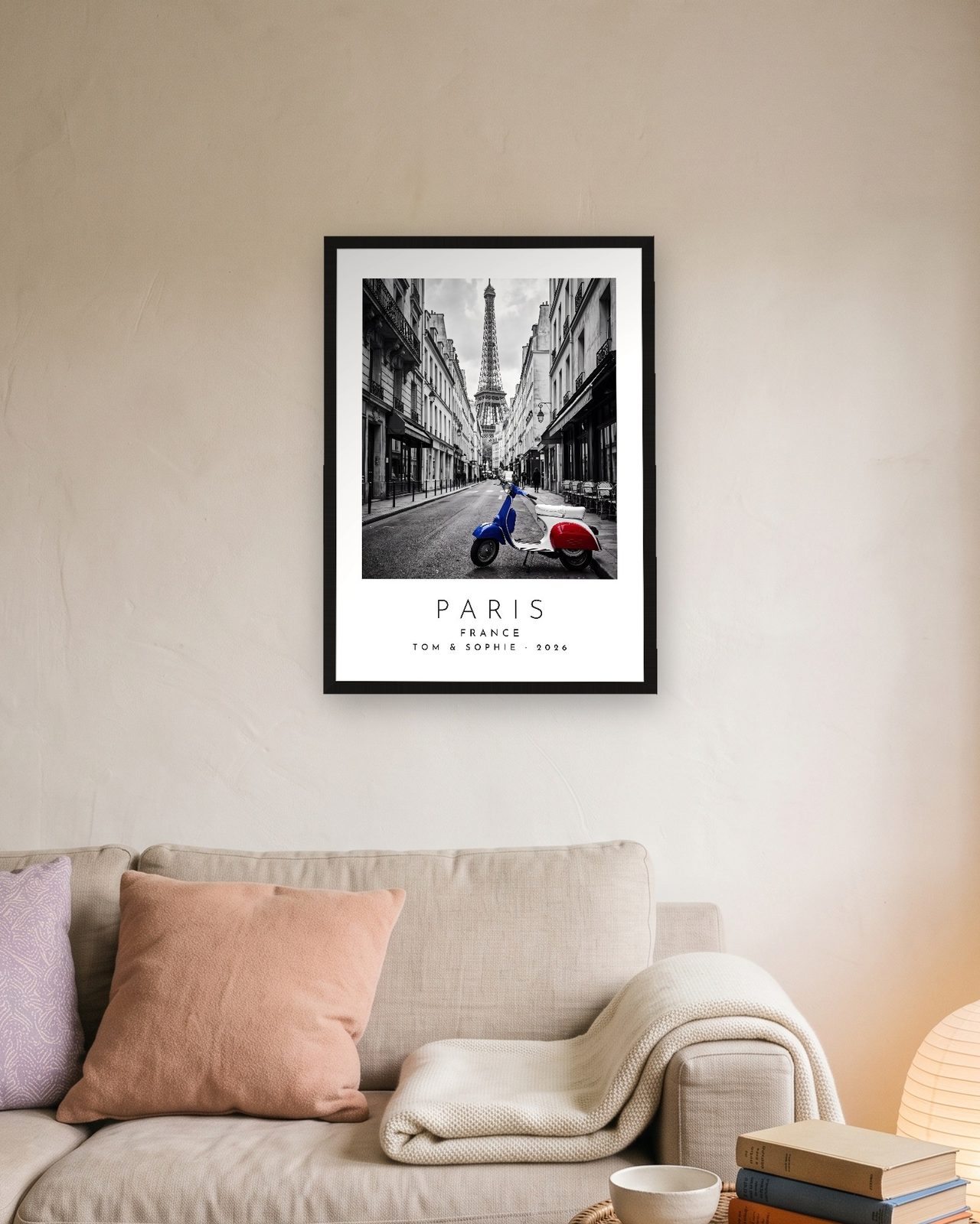 Our Trip Paris print: black frame A3 above a linen sofa, personalised TOM & SOPHIE · 2026