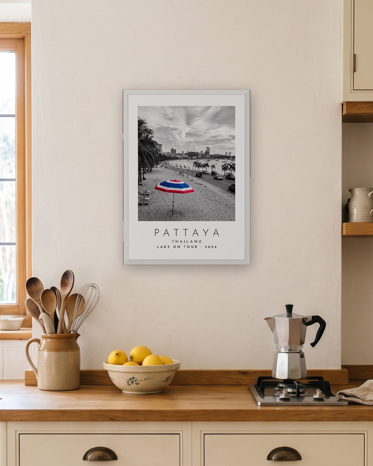 Our Trip Pattaya print: white frame A3 in a bright kitchen, personalised LADS ON TOUR · 2026