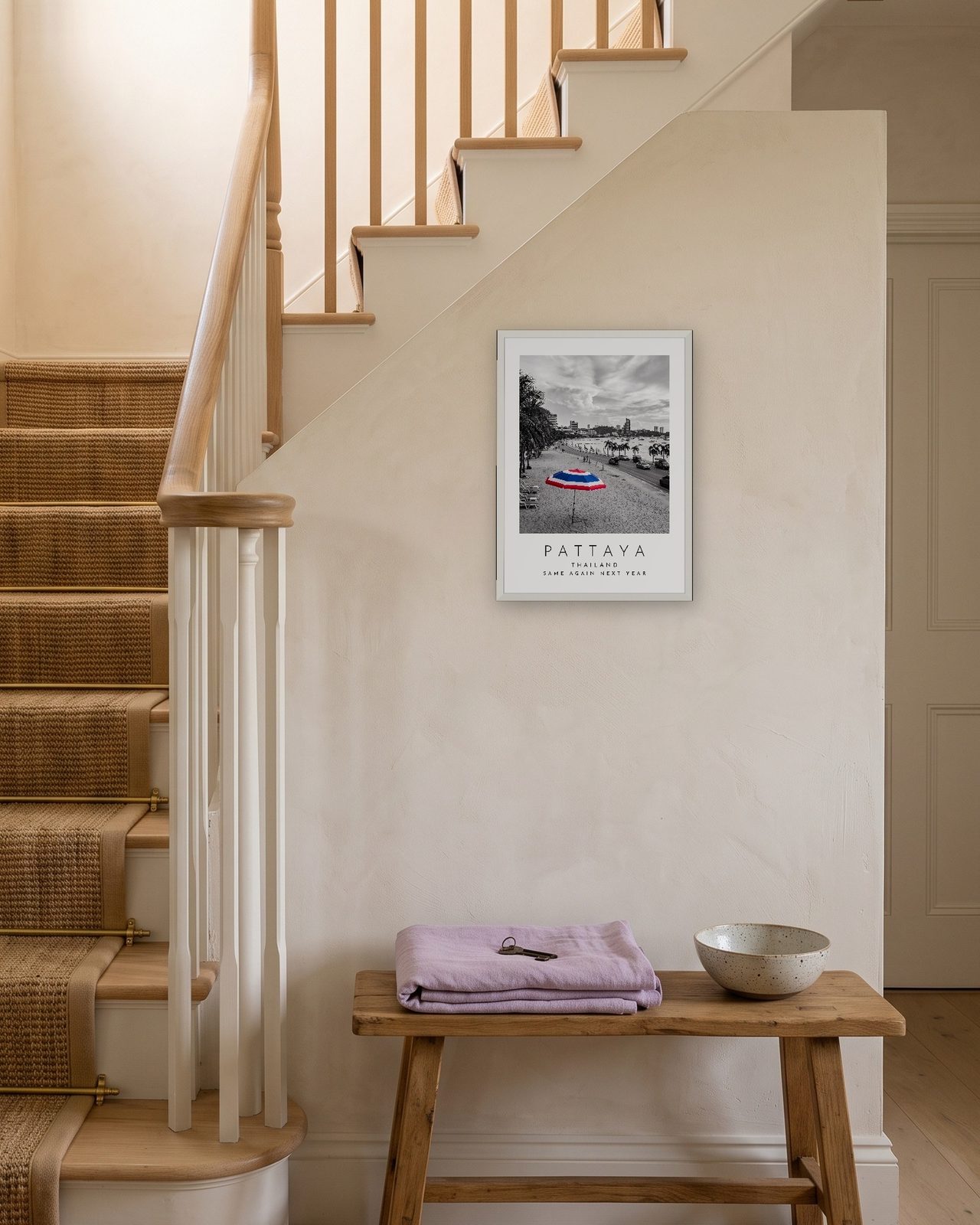 Our Trip Pattaya print: white frame A3 on a staircase wall, personalised SAME AGAIN NEXT YEAR
